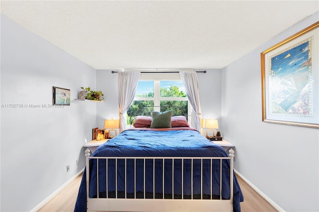 bedroom with hardwood / wood-style floors