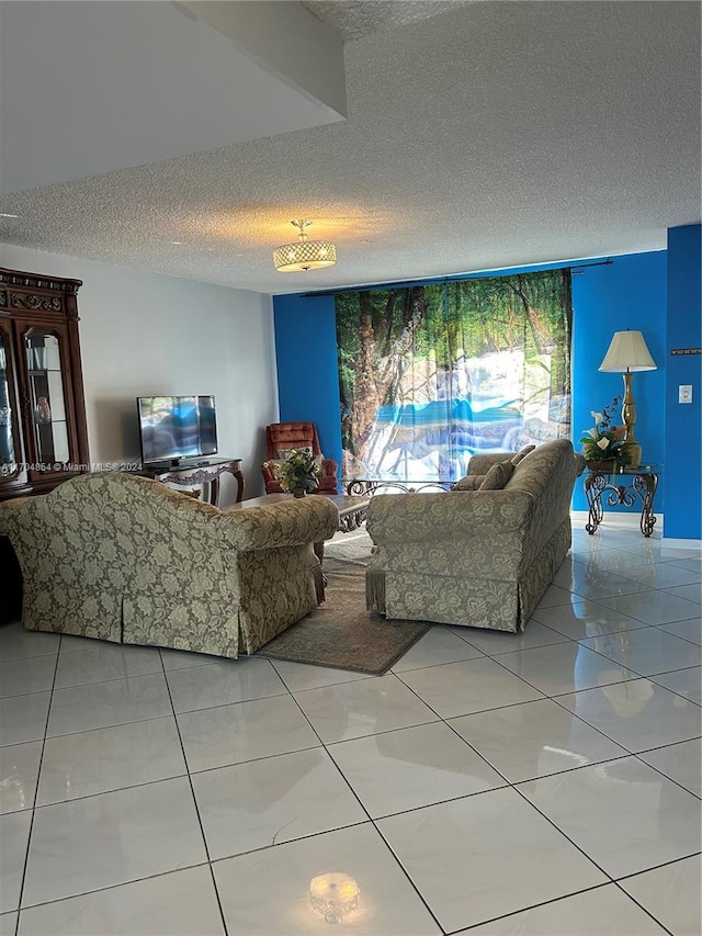 living room featuring light tile patterned floors and a textured ceiling