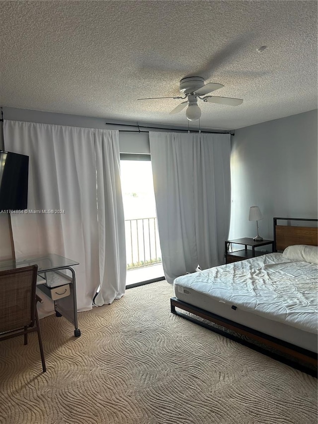 bedroom featuring ceiling fan, light colored carpet, a textured ceiling, and access to outside