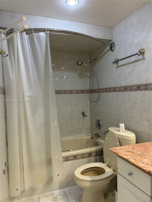 full bathroom featuring shower / bath combination with curtain, vanity, toilet, and tile walls