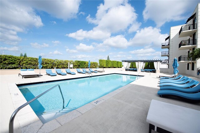 view of swimming pool with a patio and a pergola