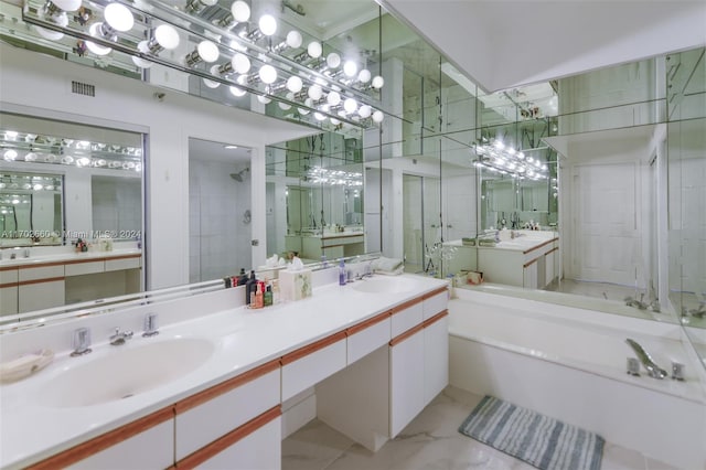 bathroom featuring vanity and shower with separate bathtub