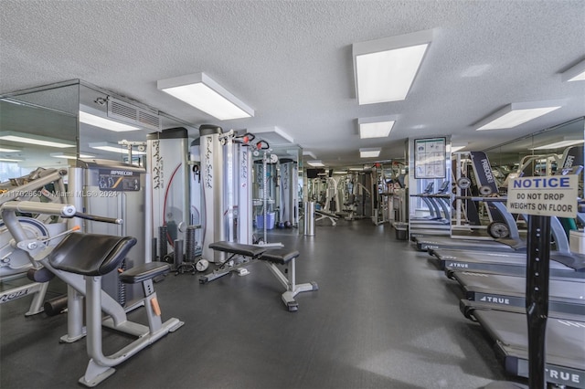 workout area featuring a textured ceiling