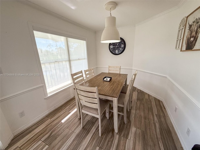 dining room featuring ornamental molding and dark hardwood / wood-style floors