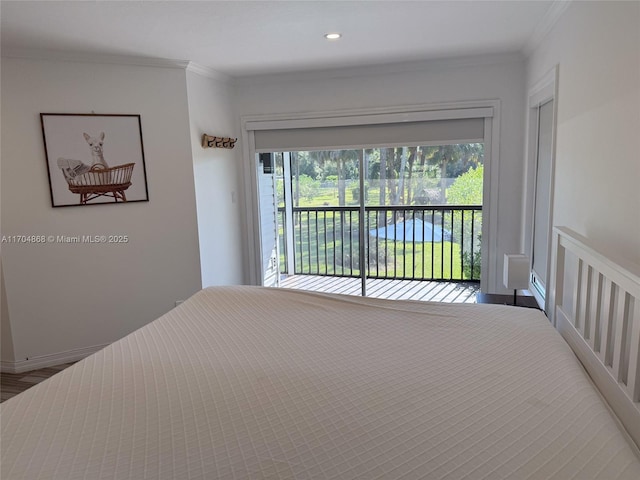 unfurnished bedroom with crown molding, access to exterior, and hardwood / wood-style floors