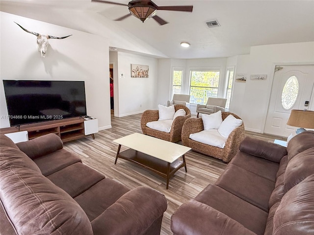 living room with ceiling fan, lofted ceiling, and light wood-type flooring