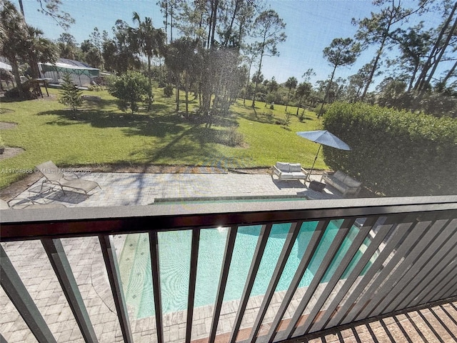 view of pool with a patio area and a lawn