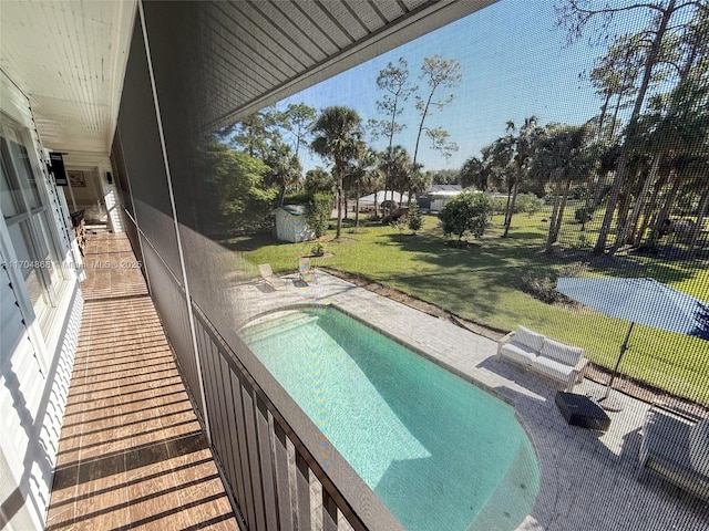 view of pool featuring a patio and a yard