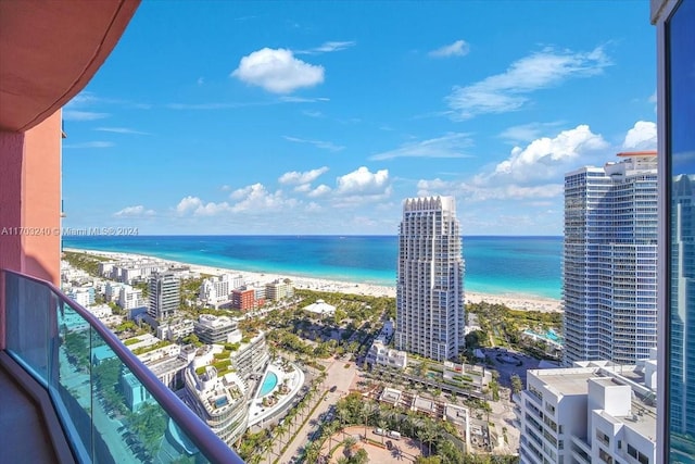 balcony featuring a water view and a beach view