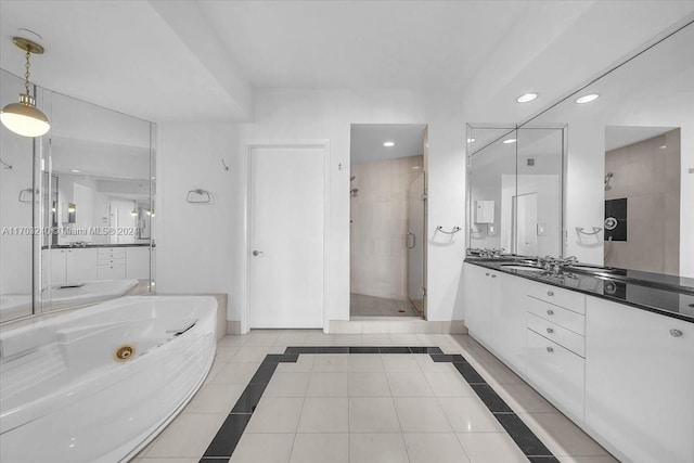 bathroom featuring tile patterned flooring, shower with separate bathtub, and vanity