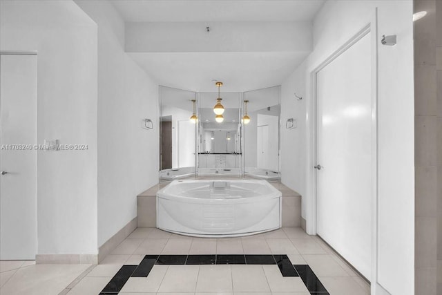 bathroom with tile patterned floors and a tub to relax in