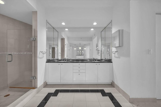 bathroom featuring tile patterned flooring, vanity, and an enclosed shower