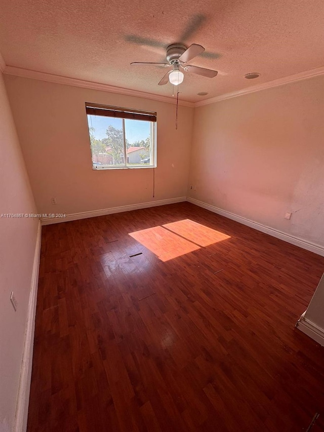 empty room with ornamental molding, a textured ceiling, ceiling fan, and dark wood-type flooring