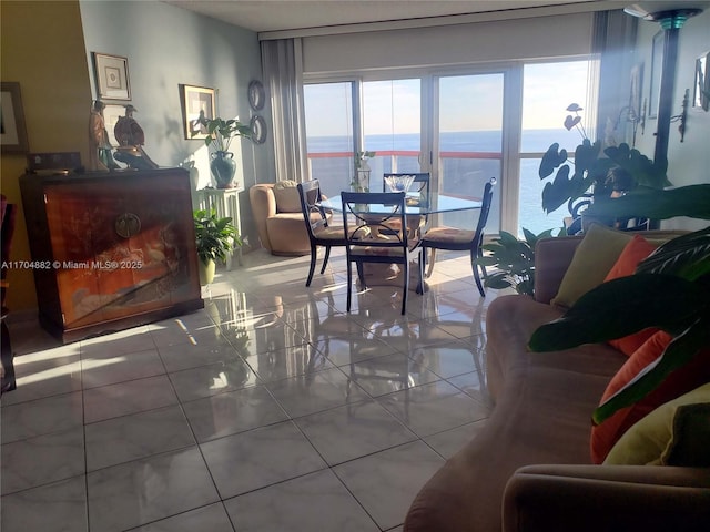 dining area with tile patterned flooring and a water view