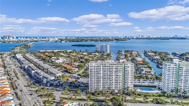 drone / aerial view featuring a city view and a water view