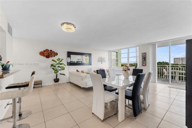 dining area featuring light tile patterned floors and visible vents
