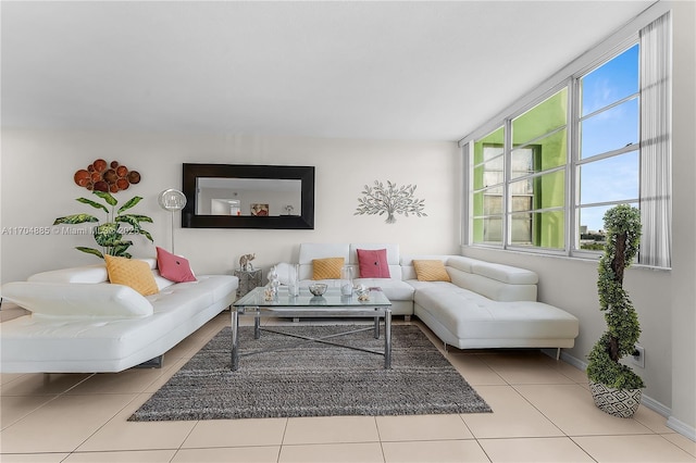 tiled living room featuring baseboards