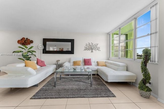 living area featuring baseboards and tile patterned floors