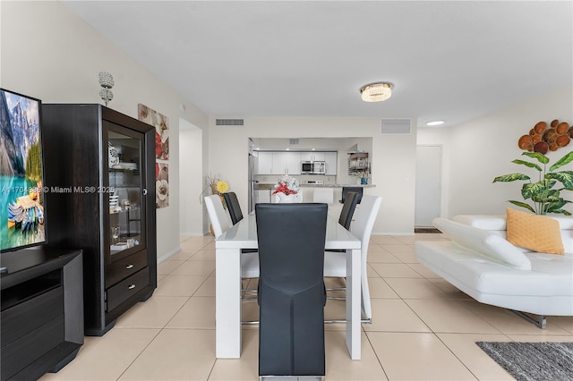 dining room featuring light tile patterned floors and visible vents