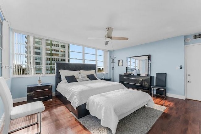 bedroom featuring ceiling fan, wood finished floors, and baseboards