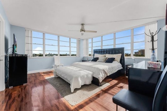 bedroom with ceiling fan and dark wood-style flooring