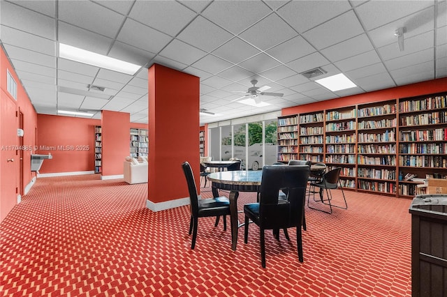 dining area featuring baseboards, a drop ceiling, carpet flooring, and visible vents
