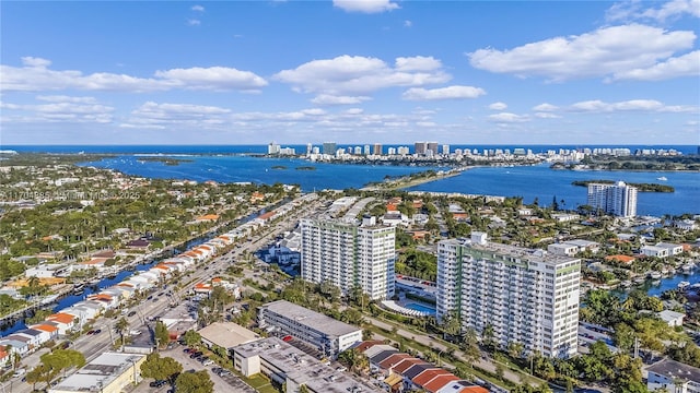 birds eye view of property featuring a water view and a city view