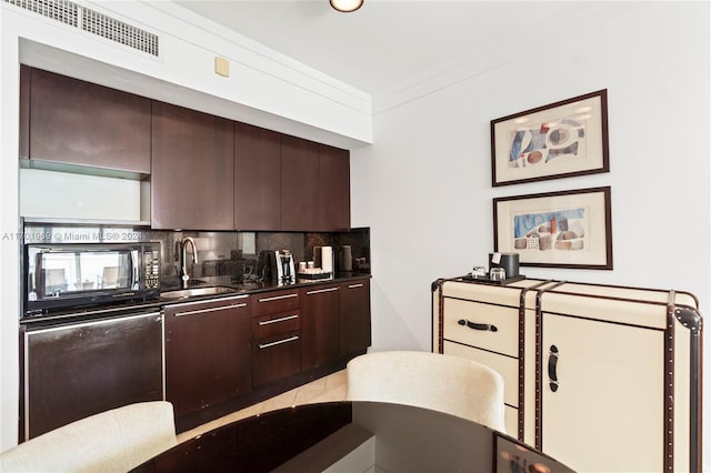 kitchen featuring sink, dishwashing machine, backsplash, dark brown cabinetry, and crown molding