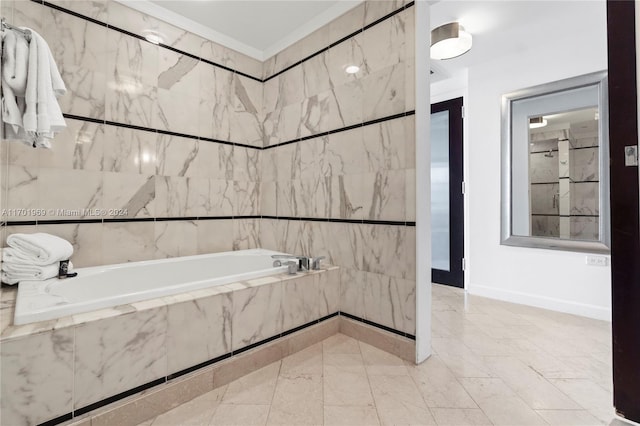 bathroom featuring tile walls and tiled tub