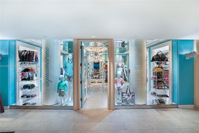 exercise room featuring expansive windows, a wealth of natural light, and light tile patterned floors