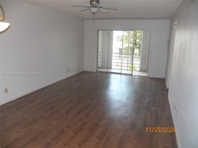 unfurnished room with ceiling fan and dark wood-type flooring