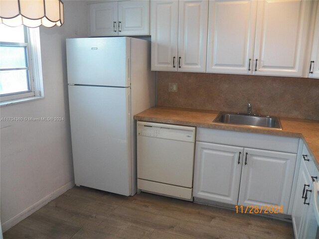 kitchen featuring white appliances, white cabinets, sink, tasteful backsplash, and dark hardwood / wood-style flooring