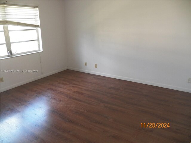 unfurnished room featuring dark hardwood / wood-style floors