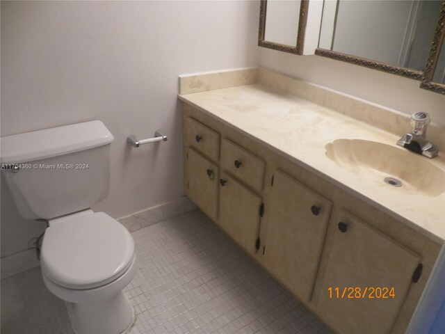 bathroom with tile patterned floors, vanity, and toilet