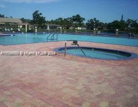 view of swimming pool with a community hot tub