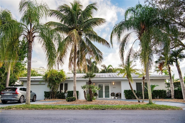 view of front of property featuring french doors and a garage