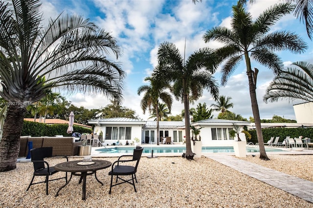 view of swimming pool with an outdoor living space and a patio