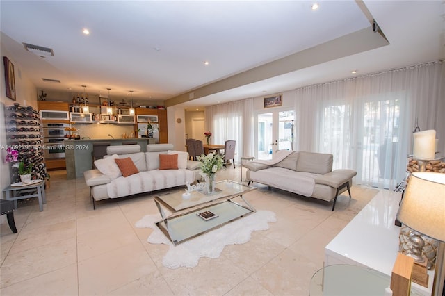 living room featuring light tile patterned floors and french doors