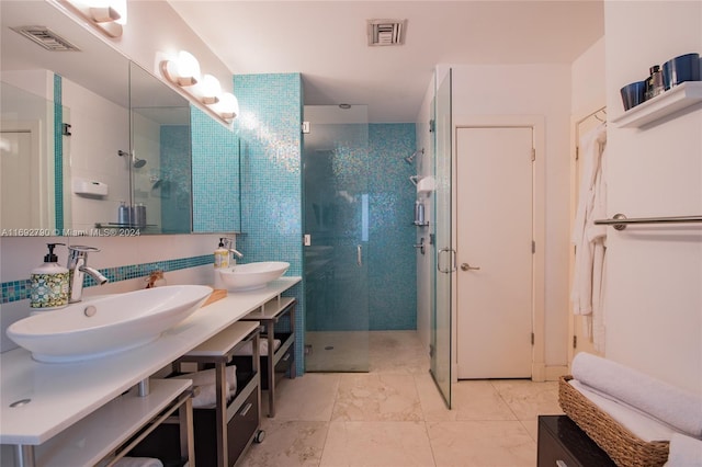 bathroom featuring vanity and a shower with door