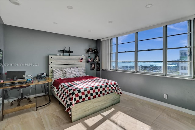 tiled bedroom with a water view