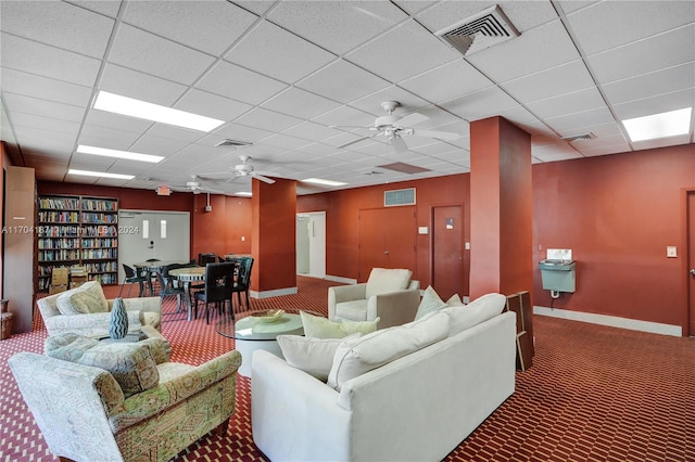 living room featuring carpet, a paneled ceiling, and ceiling fan