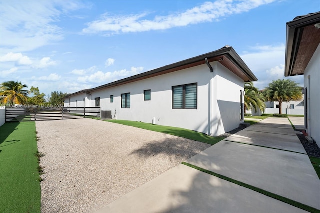 back of house with central air condition unit