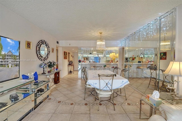 tiled dining room with a textured ceiling and a notable chandelier