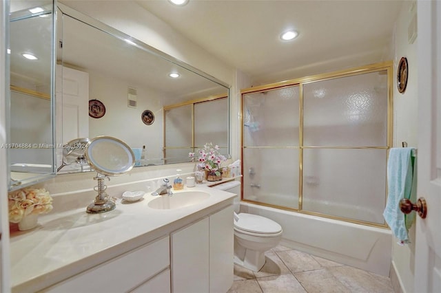 full bathroom featuring tile patterned flooring, vanity, bath / shower combo with glass door, and toilet