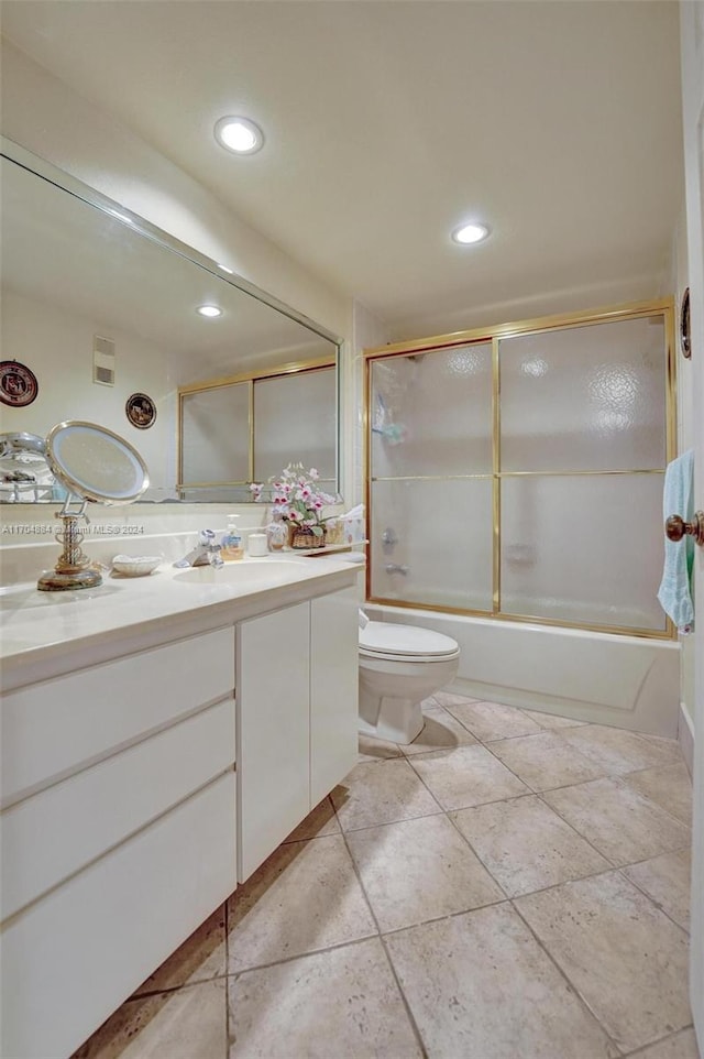 full bathroom with toilet, vanity, and combined bath / shower with glass door