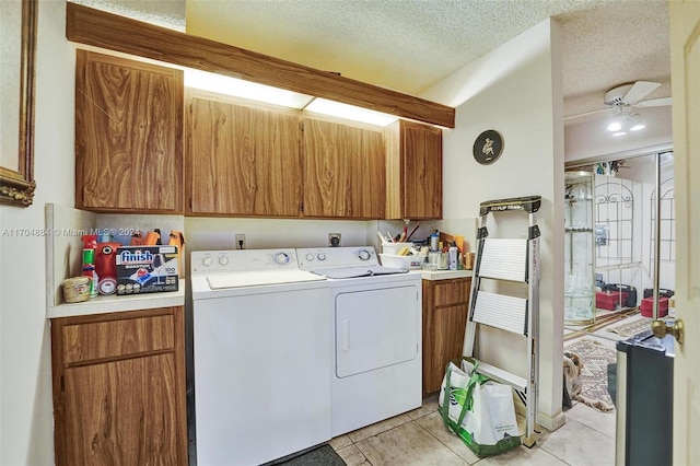 laundry area featuring cabinets, ceiling fan, washer and dryer, light tile patterned floors, and a textured ceiling