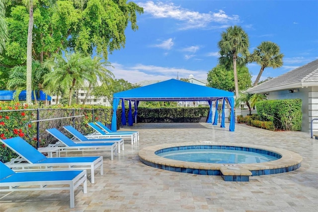 view of pool featuring a gazebo, a patio area, and a hot tub