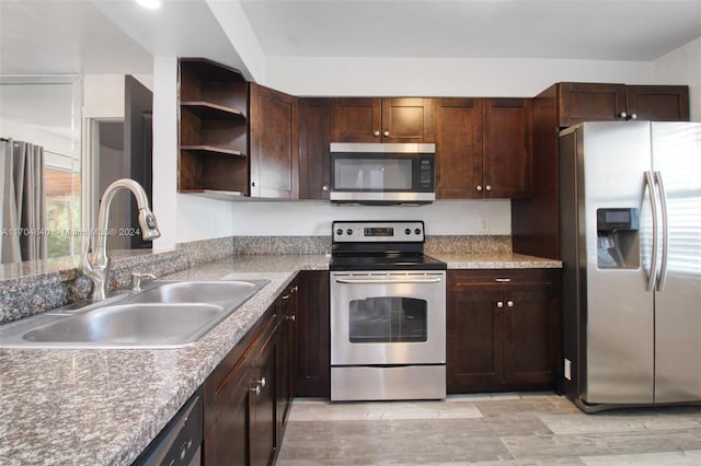 kitchen with stainless steel appliances, a sink, dark brown cabinetry, and open shelves