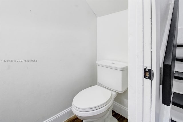 bathroom featuring baseboards, toilet, and wood finished floors