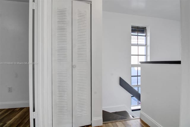 interior space with wood finished floors and baseboards